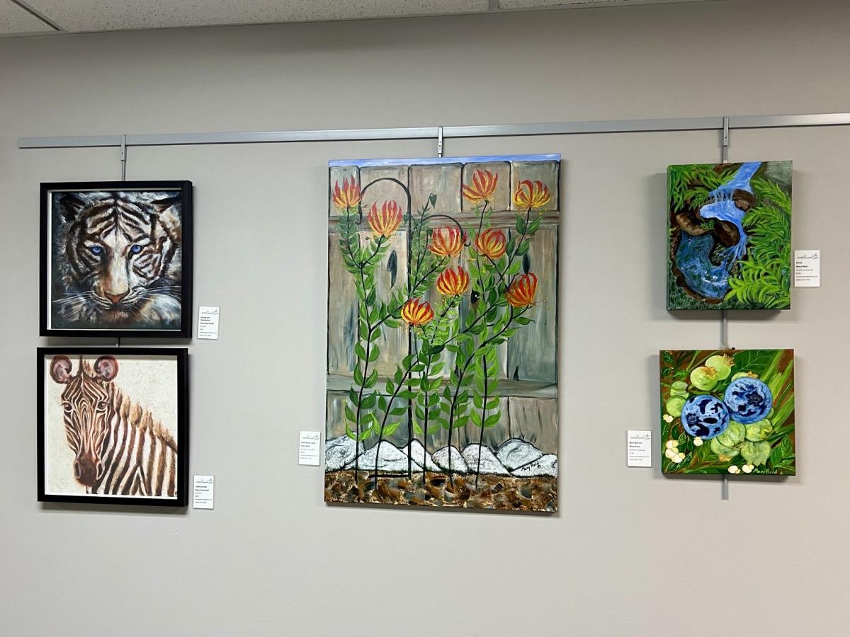 4 pieces of artwork on a wall. 
