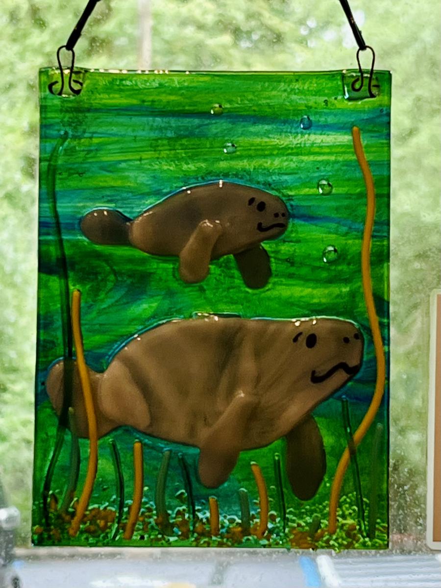 Glass artwork of manatees