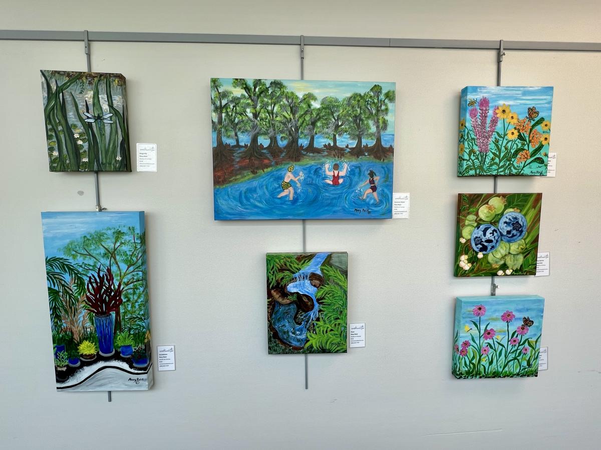Seven pieces of artwork featuring flowers, water, and trees.