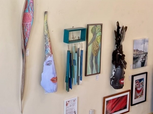 Eight pieces of artwork featuring masks, wind chimes, and paintings.