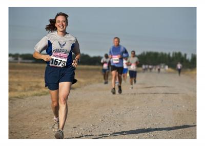 Woman running a marathon while smiling